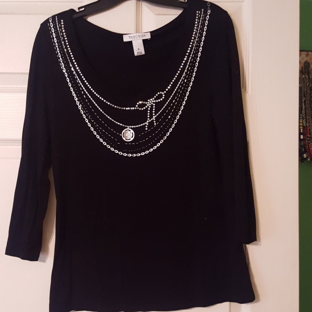 Black Shirt with silver necklace-Like detail.